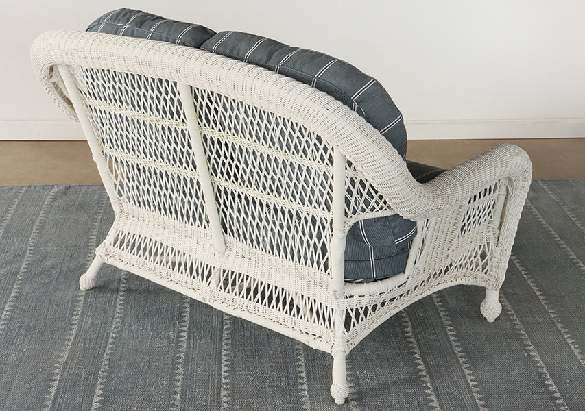 White Wicker Loveseat with Blue and White Cushion